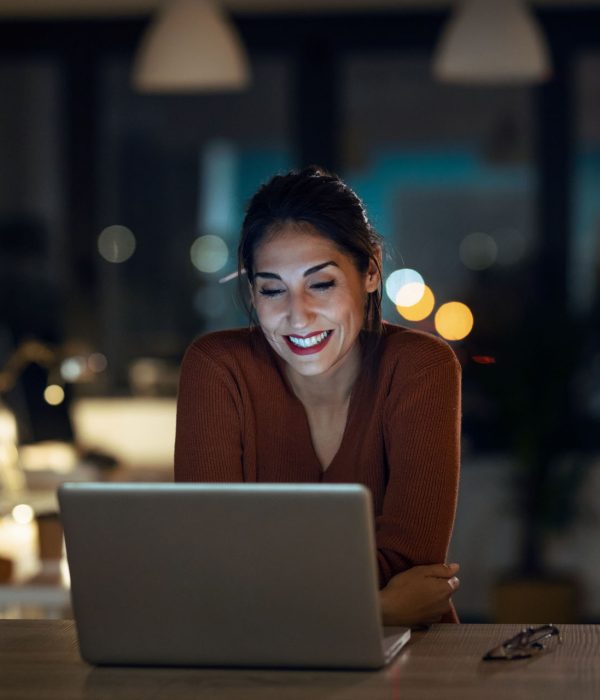 Shot of smiling beautiful business woman having an online video call via laptop computer in the office.
